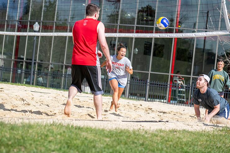 Students playing sand volleyball