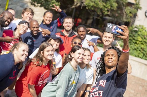 group of students on campus taking a selfie